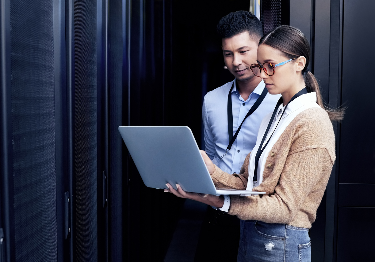 Shot of two technicians working together in a server room